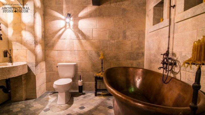 Medieval style bathroom reclaimed limestone wall cladding flooring sink copper bathtub