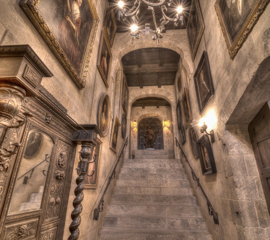 Gothic Medieval Game of Thrones style castle entrance with reclaimed limestone stair steps flooring wall cladding roman arches and rustic wood