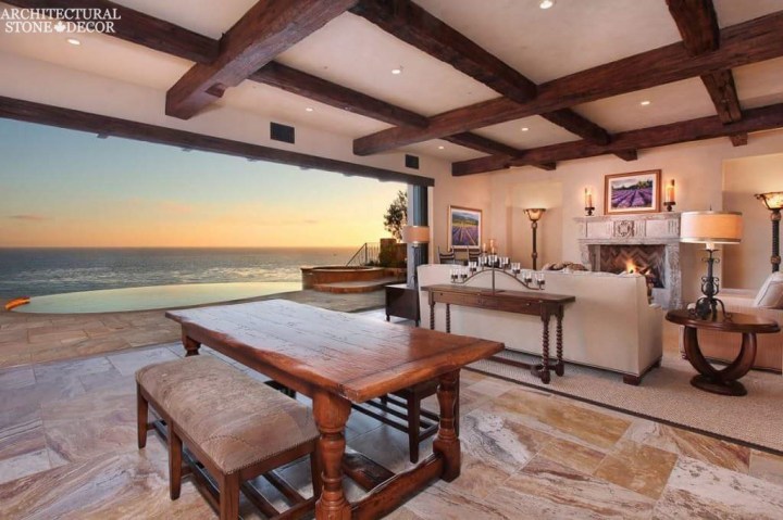 beach style living room reclaimed antique salvaged hand carved limestone natural stone fireplace mantel wood ceiling beams private poolcanada UK Australia