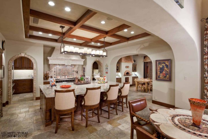 French provincial kitchen hand carved kitchen hood natural stone archways Barre Gray reclaimed salvaged antique limestone flooring Versailles pattern stone pavers tiles Canada Toronto