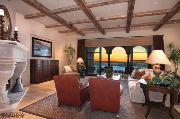 salvaged reclaimed rustic antique limestone natural stone hand carved fireplace mantel canada living room decor interior design ceiling wood beams