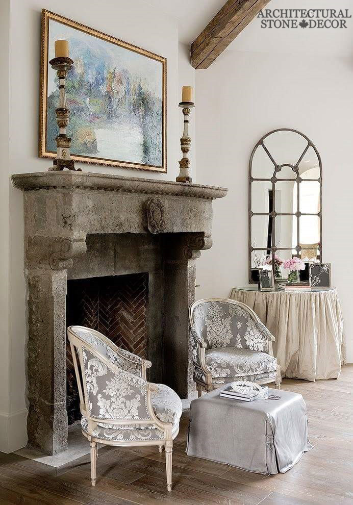 Grey earth toned salvaged reclaimed rustic antique limestone natural stone hand carved fireplace mantel canada living room decor