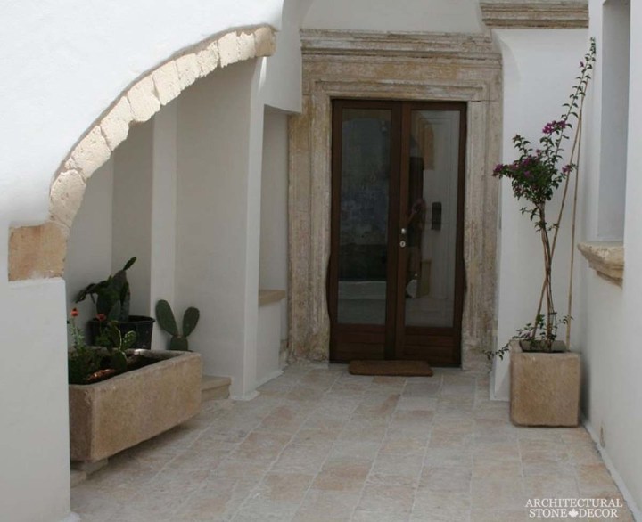 Cycladic Greek style minimalist interior home design french limestone entryway reclaimed archway Dalle de bourgogne antique french stone flooring tiles trough planters Canada