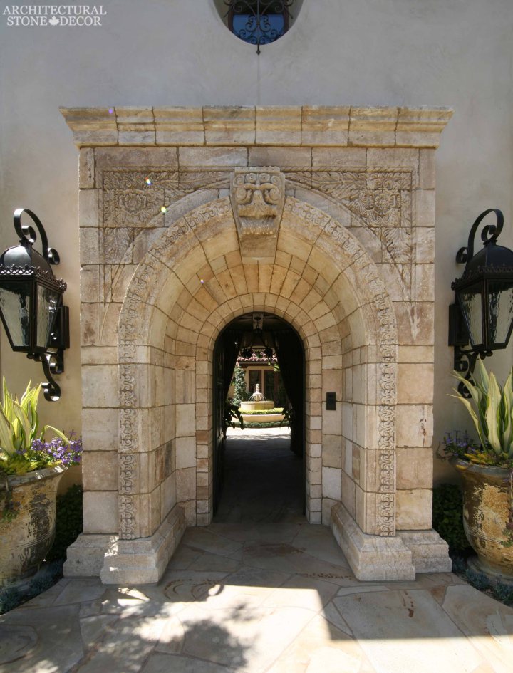 Tuscan style arched entryway heavily carved reclaimed limestone entrance old world look Canada Ontario Toronto