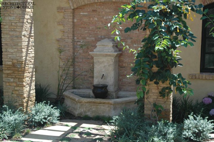 Tuscan mediterranean antique old rustic reclaimed old world natural stone hand carved limestone exterior outdoor water wall fountain garden design ideas landscape