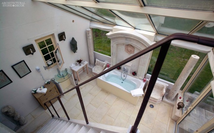 neoclassical Romanesque style master bathroom reclaimed limestone flooring wall fountain columns canada ca