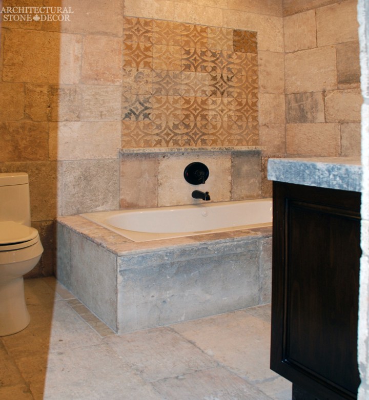 Tuscan style master bathroom reclaimed limestone flooring wall cladding bath tub canada ca