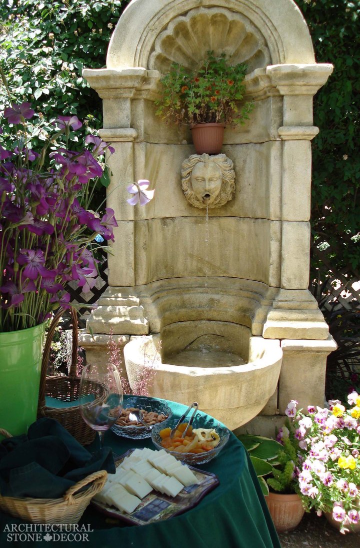 Mediterranean style garden backyard reclaimed rustic old natural stone limestone hand carved wall fountain canada ca Toronto BC