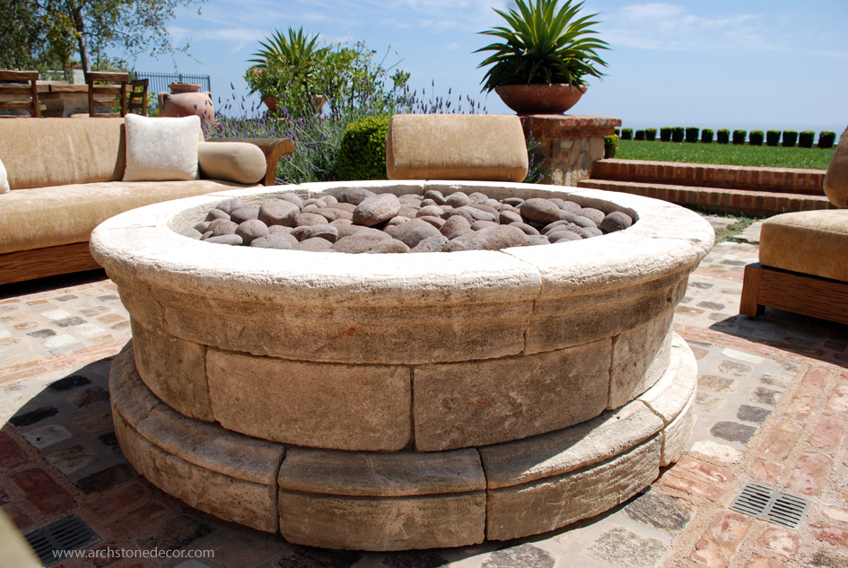 gas hand carved French limestone fire pit with basalt volcanic rock